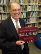 Ray Bailey of Asheville Buncombe Technical College holding College History book produced by the Bookhouse Group